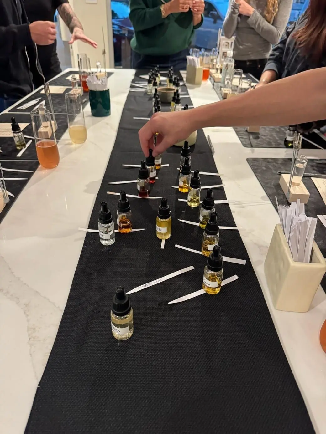 Guests blending at the perfumer's table during a workshop at The Drydown